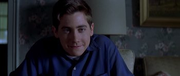 Movie still from “October Sky” (1999), directed by Joe Johnston – A person wearing a blue shirt; Close Up shot, Over the shoulder angle