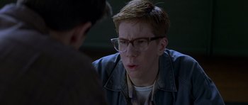 Movie still from “October Sky” (1999), directed by Joe Johnston – A young man wearing glasses and a blue jacket; Close Up shot, Over the shoulder angle