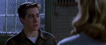 Movie still from “October Sky” (1999), directed by Joe Johnston – A man in a plaid shirt is talking to a woman; Close Up shot, Over the shoulder angle