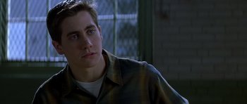 Movie still from “October Sky” (1999), directed by Joe Johnston – A young man in a plaid shirt is looking at the camera; Close Up shot, Over the shoulder angle