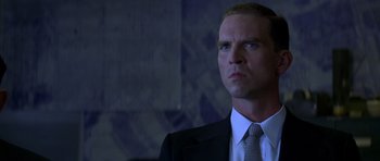 Movie still from “October Sky” (1999), directed by Joe Johnston – A man wearing a suit and tie looking up; Close Up shot, Low angle