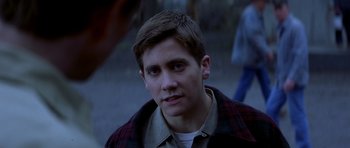 Movie still from “October Sky” (1999), directed by Joe Johnston – A young man in a plaid shirt is looking at the camera; Close Up shot, Over the shoulder angle
