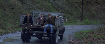 Movie still from “October Sky” (1999), directed by Joe Johnston – Two men sitting in the back of a truck; Wide shot, Low angle