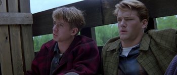 Movie still from “October Sky” (1999), directed by Joe Johnston – Two young men sitting next to each other in a vehicle; Close Up shot, Low angle