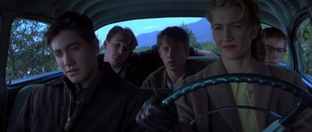 Movie still from “October Sky” (1999), directed by Joe Johnston – A group of young people riding in a car; Medium shot, Low angle