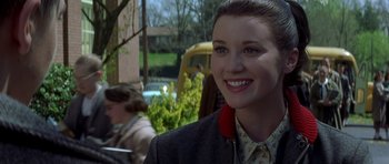 Movie still from “October Sky” (1999), directed by Joe Johnston – A woman in a suit and a red tie; Close Up shot, Over the shoulder angle