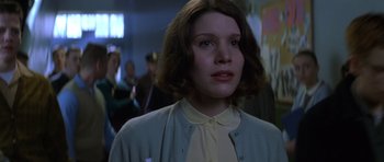 Movie still from “October Sky” (1999), directed by Joe Johnston – A young woman in a white shirt and a blue jacket; Close Up shot, Low angle