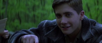 Movie still from “October Sky” (1999), directed by Joe Johnston – A young man sitting in front of a tree; Close Up shot, Over the shoulder angle
