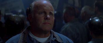 Movie still from “October Sky” (1999), directed by Joe Johnston – A man with a goatee looking into the distance; Close Up shot, Low angle