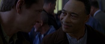 Movie still from “October Sky” (1999), directed by Joe Johnston – A man in a brown jacket talking to another man in a brown jacket; Close Up shot, Over the shoulder angle