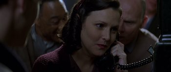 Movie still from “October Sky” (1999), directed by Joe Johnston – A woman talking on a phone while sitting in a room; Close Up shot, High angle