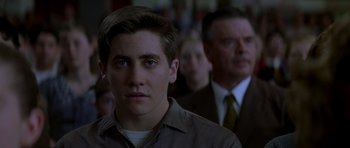 Movie still from “October Sky” (1999), directed by Joe Johnston – A young man in a brown shirt and a man in a suit; Close Up shot, Over the shoulder angle