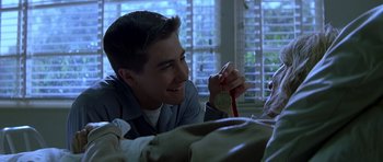 Movie still from “October Sky” (1999), directed by Joe Johnston – A young man holding a medal in his hand; Close Up shot, Over the shoulder angle