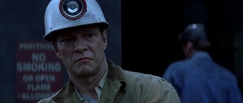 Movie still from “October Sky” (1999), directed by Joe Johnston – A person wearing a hard hat; Close Up shot, Low angle