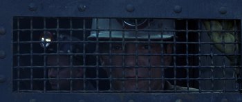 Movie still from “October Sky” (1999), directed by Joe Johnston – A man with a hard hat looking out of a jail cell; Close Up shot, High angle