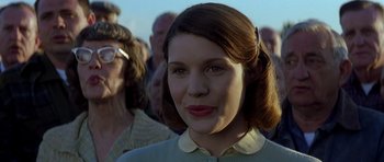 Movie still from “October Sky” (1999), directed by Joe Johnston – A person with a crowd in the background; Close Up shot, Low angle
