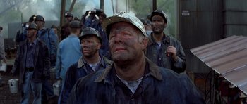 Movie still from “October Sky” (1999), directed by Joe Johnston – A group of men standing next to each other; Medium shot, High angle