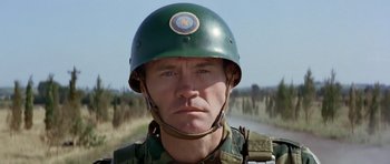 Movie still from “Octopussy” (1983), directed by John Glen – A man in a military uniform wearing a helmet; Close Up shot, Low angle