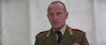 Movie still from “Octopussy” (1983), directed by John Glen – A person wearing a military uniform; Close Up shot, Low angle