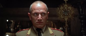 Movie still from “Octopussy” (1983), directed by John Glen – A person wearing a military uniform; Close Up shot, Low angle