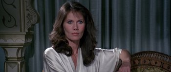 Movie still from “Octopussy” (1983), directed by John Glen – A beautiful woman with long brown hair holding a comb; Close Up shot, Over the shoulder angle