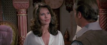 Movie still from “Octopussy” (1983), directed by John Glen – A woman in a white shirt is talking to a man in a suit; Close Up shot, Over the shoulder angle