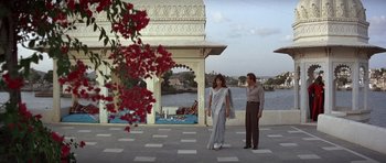 Movie still from “Octopussy” (1983), directed by John Glen – A man and a woman standing next to each other; Wide shot, High angle