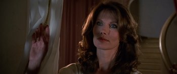 Movie still from “Octopussy” (1983), directed by John Glen – A person with long brown hair; Close Up shot, Low angle