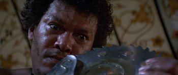 Movie still from “Octopussy” (1983), directed by John Glen – A person holding a water balloon; Close Up shot, Low angle