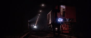 Movie still from “Octopussy” (1983), directed by John Glen – A train traveling down train tracks in a tunnel; Extreme Wide shot, Low angle