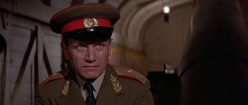 Movie still from “Octopussy” (1983), directed by John Glen – A person wearing a military uniform; Close Up shot, Low angle