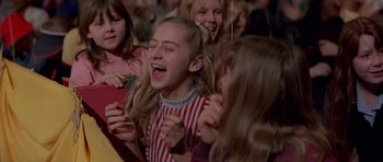 Movie still from “Octopussy” (1983), directed by John Glen – A group of young girls laughing and clapping; Medium shot, Low angle