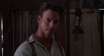 Movie still from “Of Mice and Men” (1992), directed by Gary Sinise – A person wearing suspenders; Close Up shot, Low angle