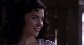 Movie still from “Of Mice and Men” (1992), directed by Gary Sinise – A beautiful woman with long dark curly hair; Close Up shot, Over the shoulder angle