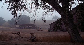 Movie still from “Of Mice and Men” (1992), directed by Gary Sinise – A man standing in the middle of an open field; Extreme Wide shot, High angle