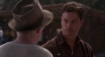 Movie still from “Of Mice and Men” (1992), directed by Gary Sinise – A man in a hat and a plaid shirt talking to another man in a hat; Close Up shot, Over the shoulder angle