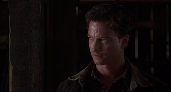 Movie still from “Of Mice and Men” (1992), directed by Gary Sinise – A person wearing a jacket; Close Up shot, Over the shoulder angle