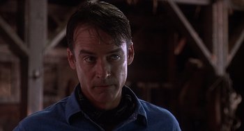 Movie still from “Of Mice and Men” (1992), directed by Gary Sinise – A person wearing a blue shirt; Close Up shot, Low angle
