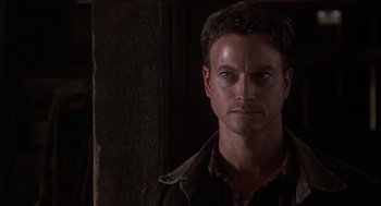 Movie still from “Of Mice and Men” (1992), directed by Gary Sinise – A person wearing a jacket; Close Up shot, Over the shoulder angle