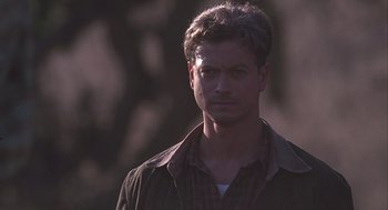 Movie still from “Of Mice and Men” (1992), directed by Gary Sinise – A person wearing a jacket; Close Up shot, Over the shoulder angle