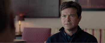 Movie still from “Office Christmas Party” (2016), directed by Will Speck – A person sitting in a chair; Close Up shot, Over the shoulder angle