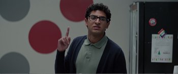 Movie still from “Office Christmas Party” (2016), directed by Will Speck – A man with glasses is pointing up; Close Up shot, Over the shoulder angle
