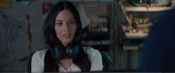 Movie still from “Office Christmas Party” (2016), directed by Will Speck – A woman wearing headphones sitting in front of a computer monitor; Close Up shot, High angle
