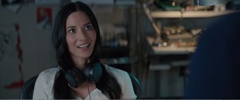 Movie still from “Office Christmas Party” (2016), directed by Will Speck – A woman with headphones sitting in front of a computer monitor; Close Up shot, Over the shoulder angle