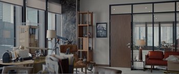 Movie still from “Office Christmas Party” (2016), directed by Will Speck – A living room with furniture and a picture on the wall; Wide shot, Over the shoulder angle