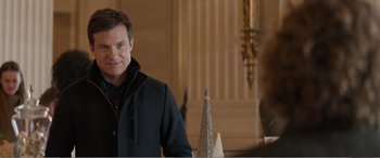 Movie still from “Office Christmas Party” (2016), directed by Will Speck – A man standing next to a christmas tree in a room; Medium shot, Over the shoulder angle