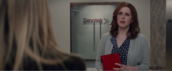 Movie still from “Office Christmas Party” (2016), directed by Will Speck – A woman holding an ipad in her hands; Medium shot, Over the shoulder angle