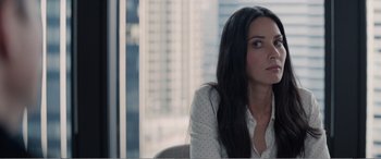 Movie still from “Office Christmas Party” (2016), directed by Will Speck – A woman sitting in front of a large window; Close Up shot, High angle