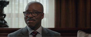 Movie still from “Office Christmas Party” (2016), directed by Will Speck – A person wearing a suit and tie; Close Up shot, Over the shoulder angle