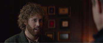 Movie still from “Office Christmas Party” (2016), directed by Will Speck – A person wearing a suit; Close Up shot, Over the shoulder angle